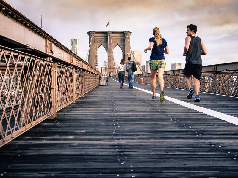Two runners on Brooklyn Bridge, New York City